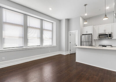 Interior living space with newly renovated kitchen and windows at Dickinson Lofts luxury lofts for rent in Grays Ferry