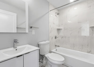 Newly renovated bathroom with sink, toilet, and shower/tub combo at Dickinson Lofts luxury lofts for rent in Grays Ferry