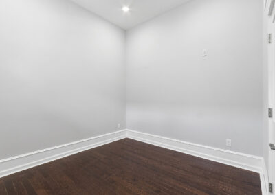 Empty room with high ceilings and hardwood floors at Dickinson Lofts luxury lofts for rent in Grays Ferry