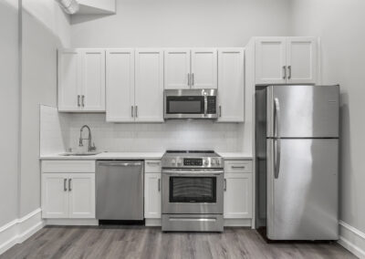 Newly renovated kitchen with hardwood floors and stainless steel appliances at Dickinson Lofts luxury lofts for rent in Grays Ferry