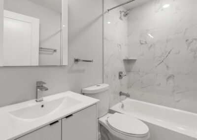 Newly renovated bathroom with sink, toilet, and shower/tub combo at Dickinson Lofts luxury lofts for rent