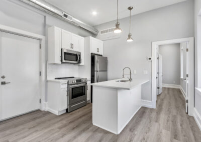 Newly renovated kitchen with island at Dickinson Lofts luxury lofts for rent in Grays Ferry