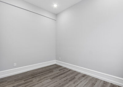 Empty interior room with hardwood floors and high ceilings at Dickinson Lofts luxury lofts for rent in Grays Ferry